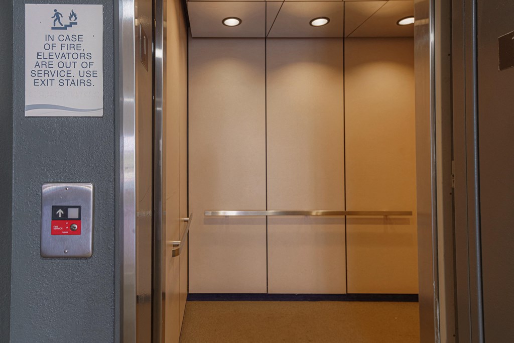 an elevator with a sign on the side of it